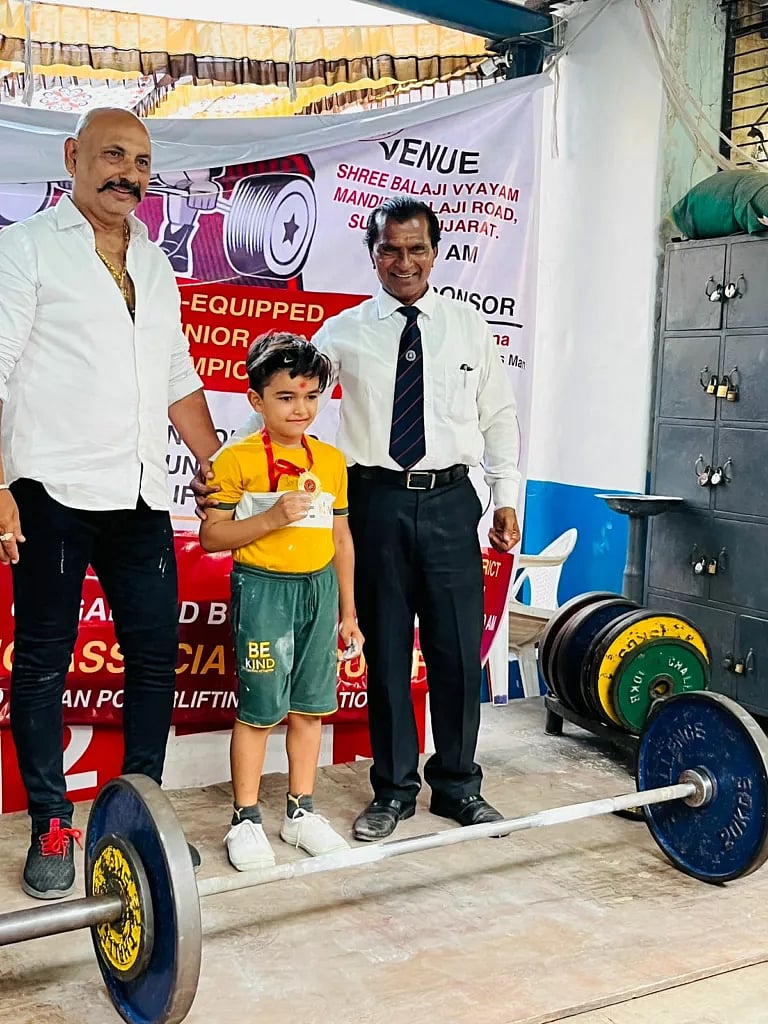 Yati posing with officials at a competition. Photo courtesy: Ravi Jethva