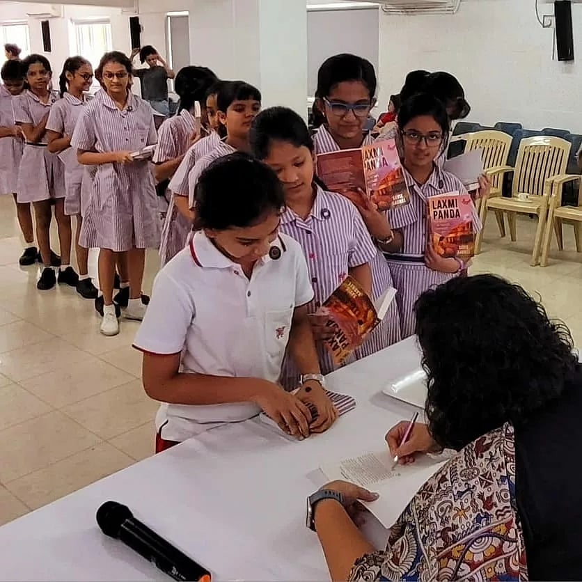 Savie Karnel signs her book on Laxmi Panda for children. Photo courtesy: Sameer Srivastava