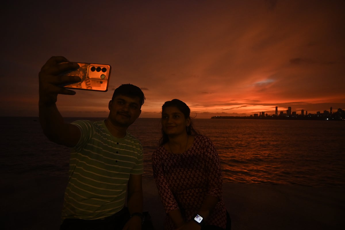 Visitors enjoy the beautiful sunset at Marine Drive on Sunday