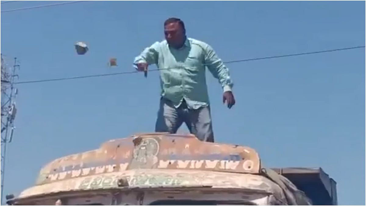 VIDEO: Man Climbs Truck, Threatens Suicide By Touching Live Wires Outside Peddapalli RTO Office, Throws Cash Alleging Bribery Demand