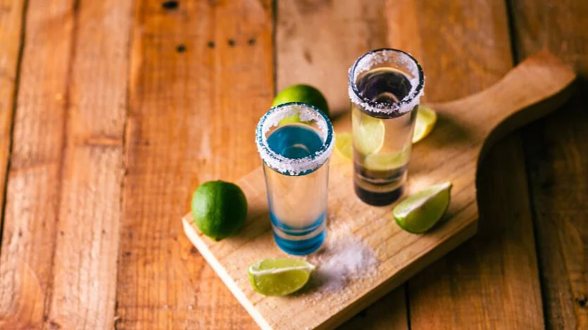Salt and lemon usually accompany a glass of tequila as they have the ability to lessen the raw burning sensation when you're drinking straight shots.