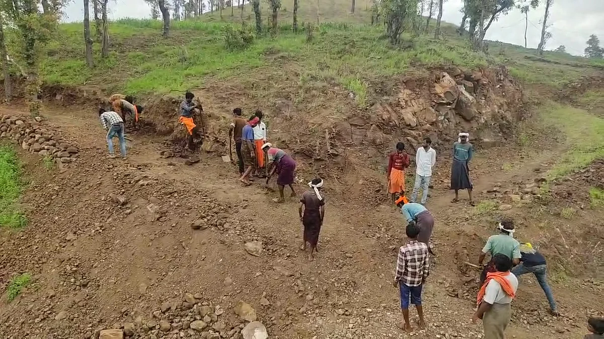 A youth digging a hill to make a path | FP Photo