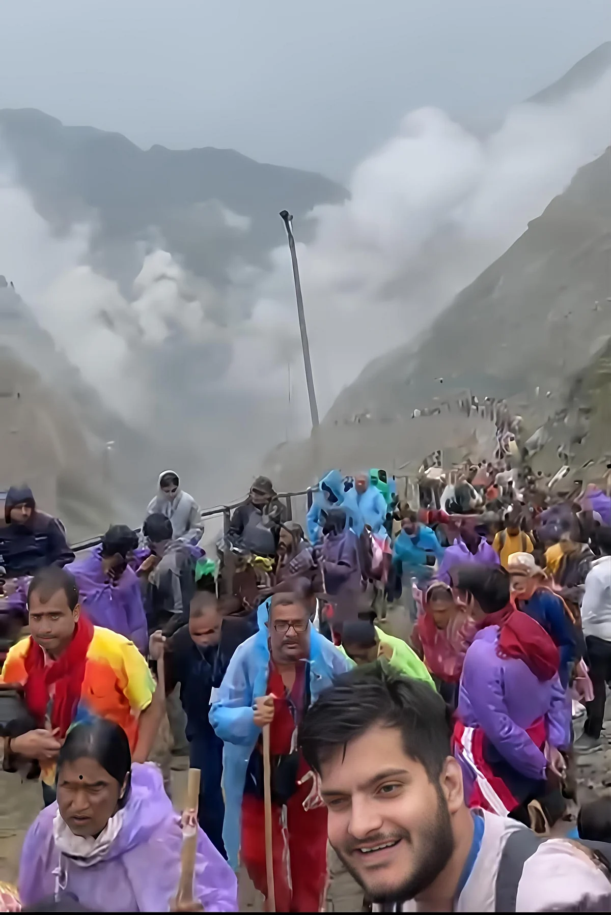 Devotees trekking through misty mountains on path to the Amarnath Cave