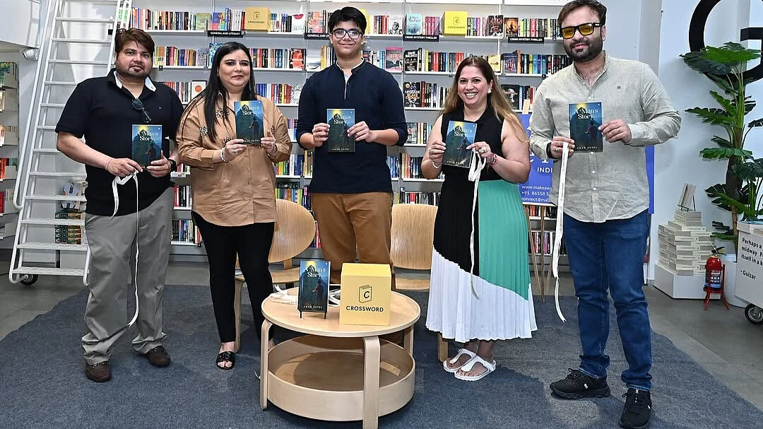 Aman poses with his family at the book launch.