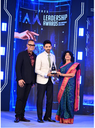 (L-R) - Neeraj Roy, Founder, Hungama Digital Media Entertainment Ltd; Nandini Dias, Chairperson, IAA Leadership Awards, felicitating kartik Aaryan