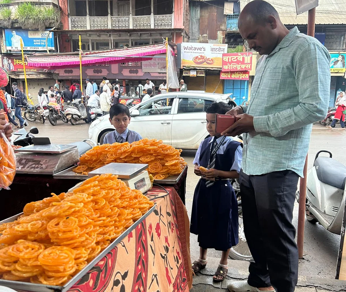 Children eagerly wait for the flag ceremony to end, knowing that warm, crispy jalebis await them.
