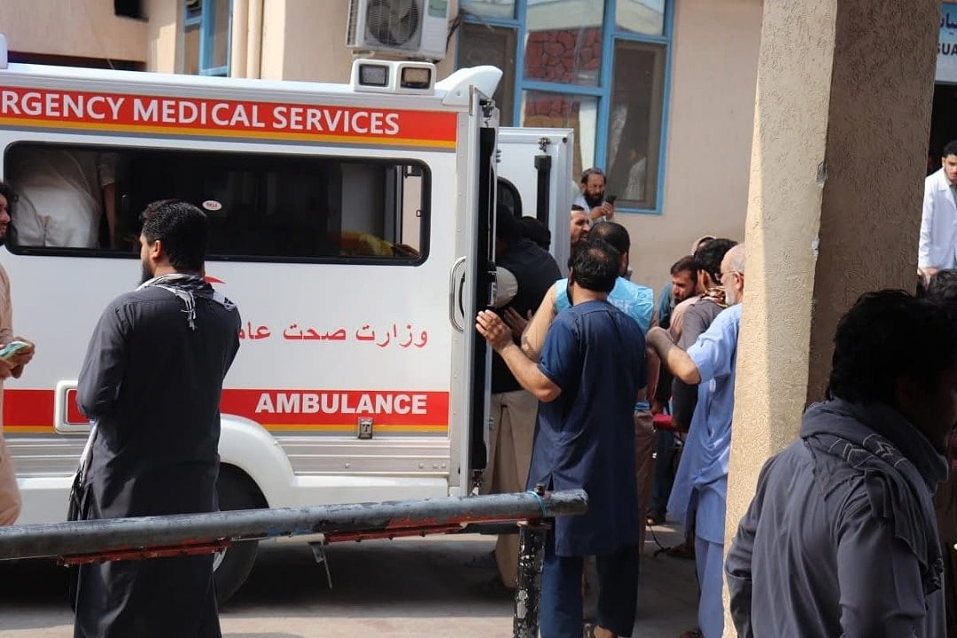 Emergency response teams load patients into ambulances as hospitals continue to receive the injured throughout the day.