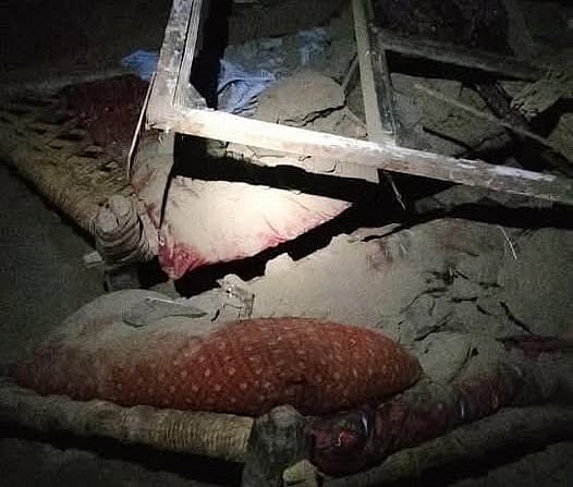 A collapsed home in one of the worst-hit villages, where locals continue to dig through debris for trapped residents.