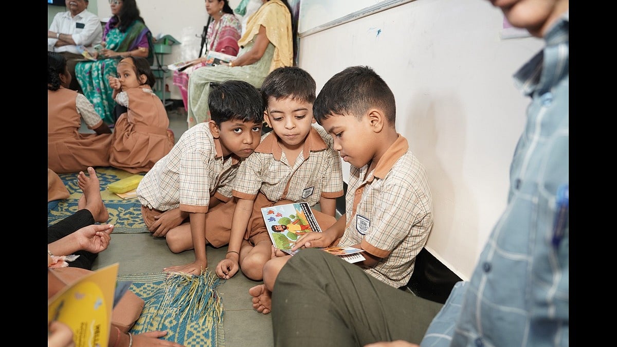 Young students at Khoj School, run by Apni Shala Foundation, at the Limboni Baug municipal school in Govandi, checking the books