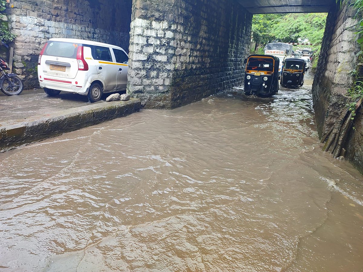 An underpass in Khadki was flooded with heavy downpour on Friday, where the commuters were seen struggling to pass through the waterlogging.