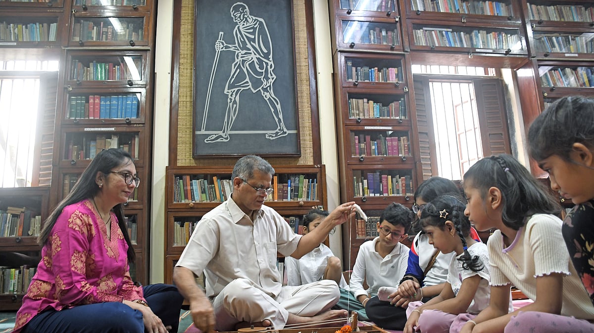 Children learn spinning wheel during their visit at Mani Bhavan on occasion of Gandhi Jayanti in Mumbai  | SALMAN ANSARI