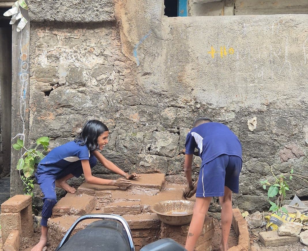 Kids making mud forts in Pune