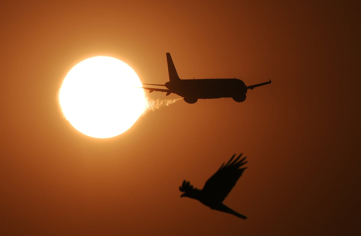 An aeroplane takeoff from Mumbai airport against the backdrop
of the setting sun