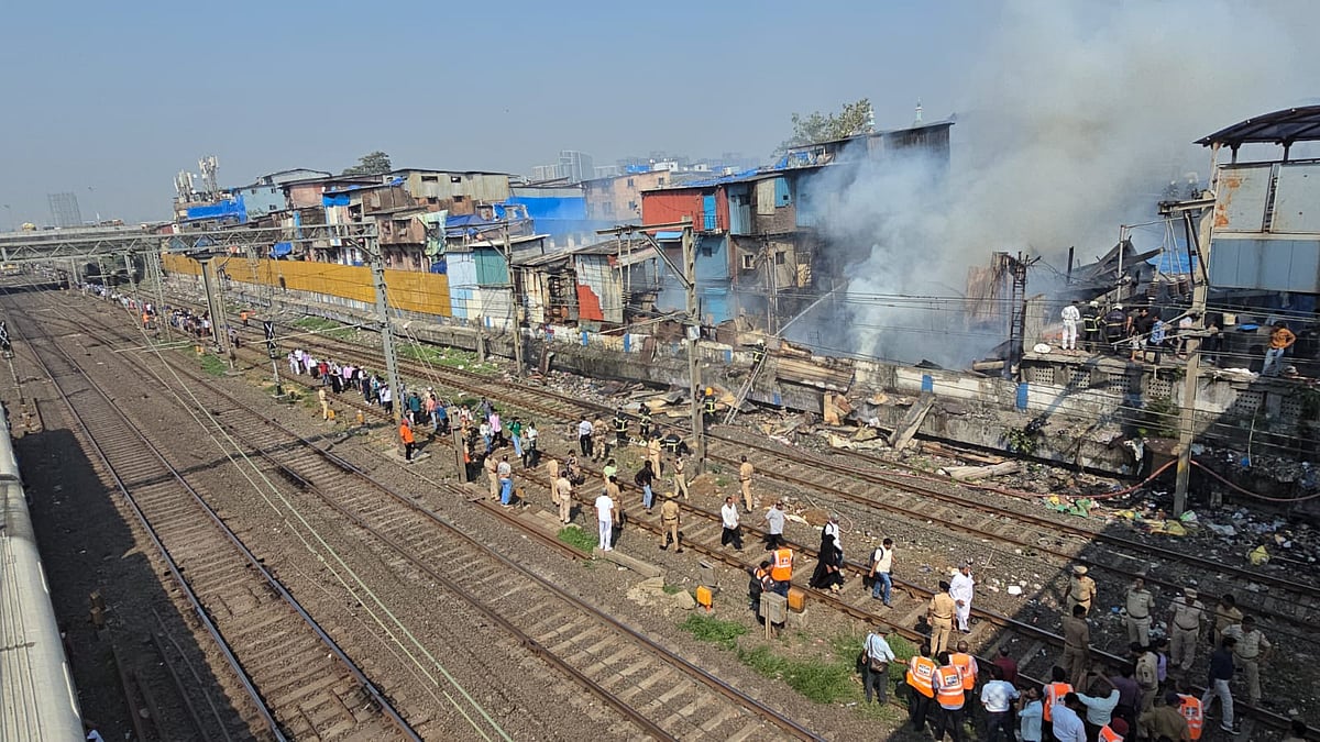 commuters walk on railway track