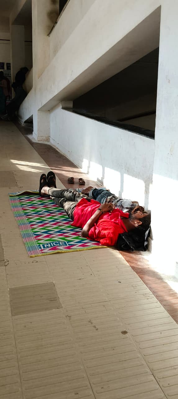 Patients’ attendants sleeping on the ramp used for carrying patients on stretchers from one floor to the other