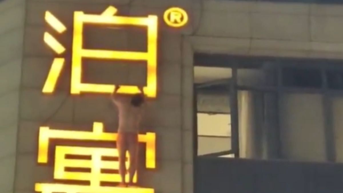 Semi-Naked Man Climbs Out Of Hotel Window, Hangs Onto Signboard After Being Caught Cheating By Wife...
