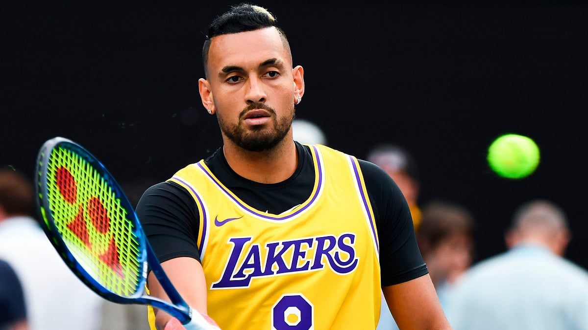 Australia's Nick Kyrgios wearing a Los Angeles Lakers jersey with former basketball player Kobe Bryant's number warms up to play against Spain's Rafael Nadal during their men's singles match on day eight of the Australian Open tennis tournament in Melbourne on January 27, 2020. | AFP