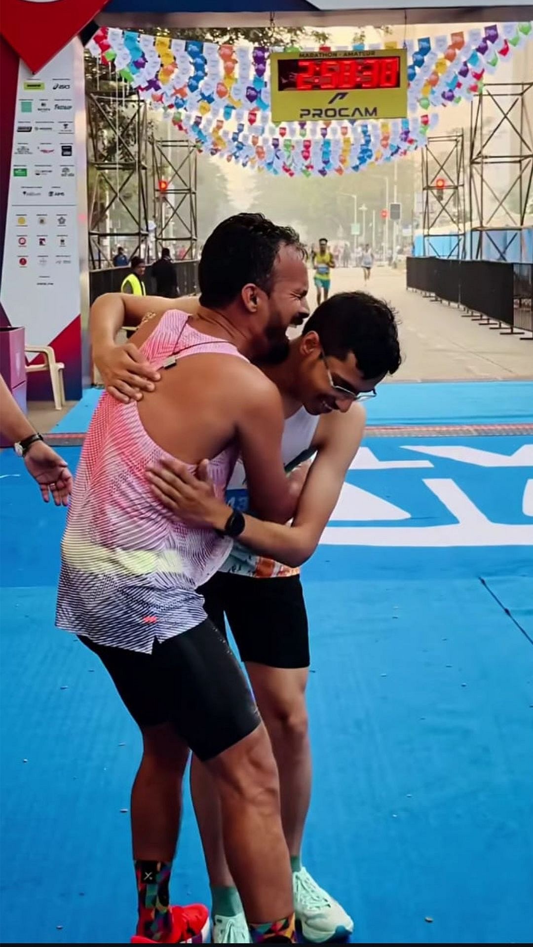 Beyond competition, the marathon reveals its human side as one runner supports another at the finish.