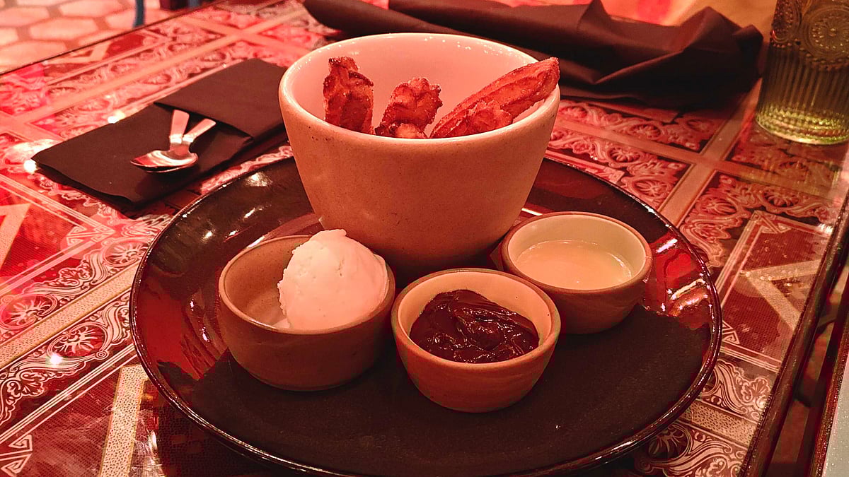 Churros with vanilla ice cream, chocolate sauce and a dip. 