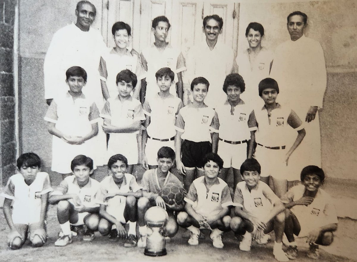 The under 13 boys Bombay city champions 1981! 
Reza is third on the bottom row from the left, next to the trophy.