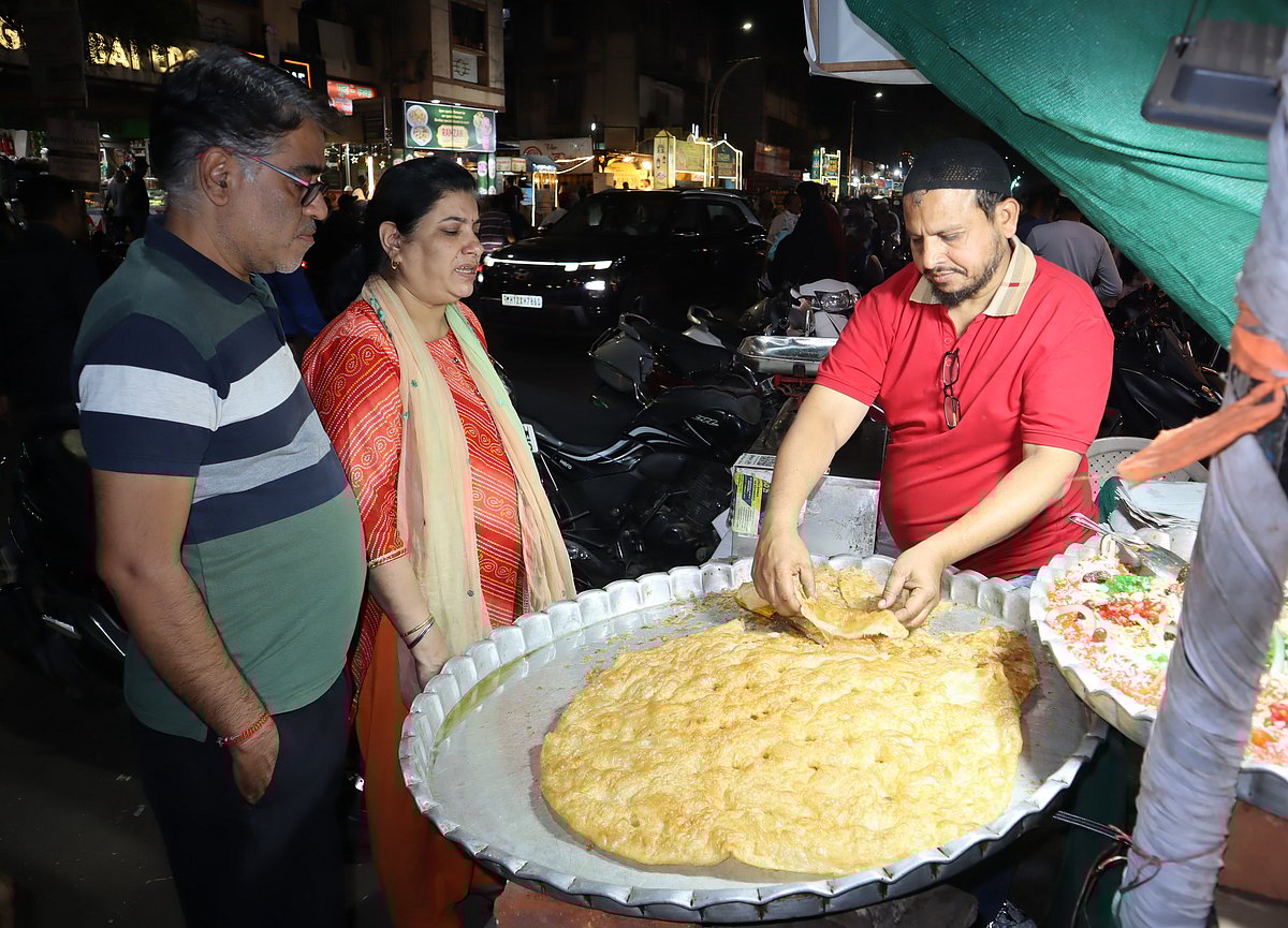 The smell of kebabs, biryani and fried snacks fills the air