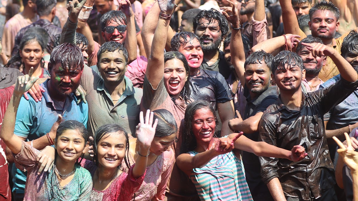 Youth cheer and celebrate as they enjoy Holi with colours and water during the ‘Rang Barse’ event
