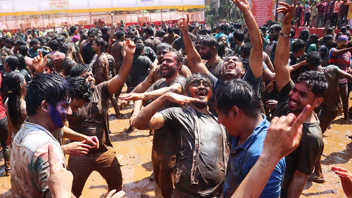roups of friends laugh and dance as they drench each other in colours and water during the lively celebrations.