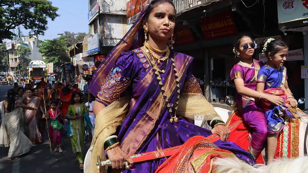 A Young Woman In A Traditional Nauvari Saree Rides Proudly On Horseback During A Grand Shobhayatra