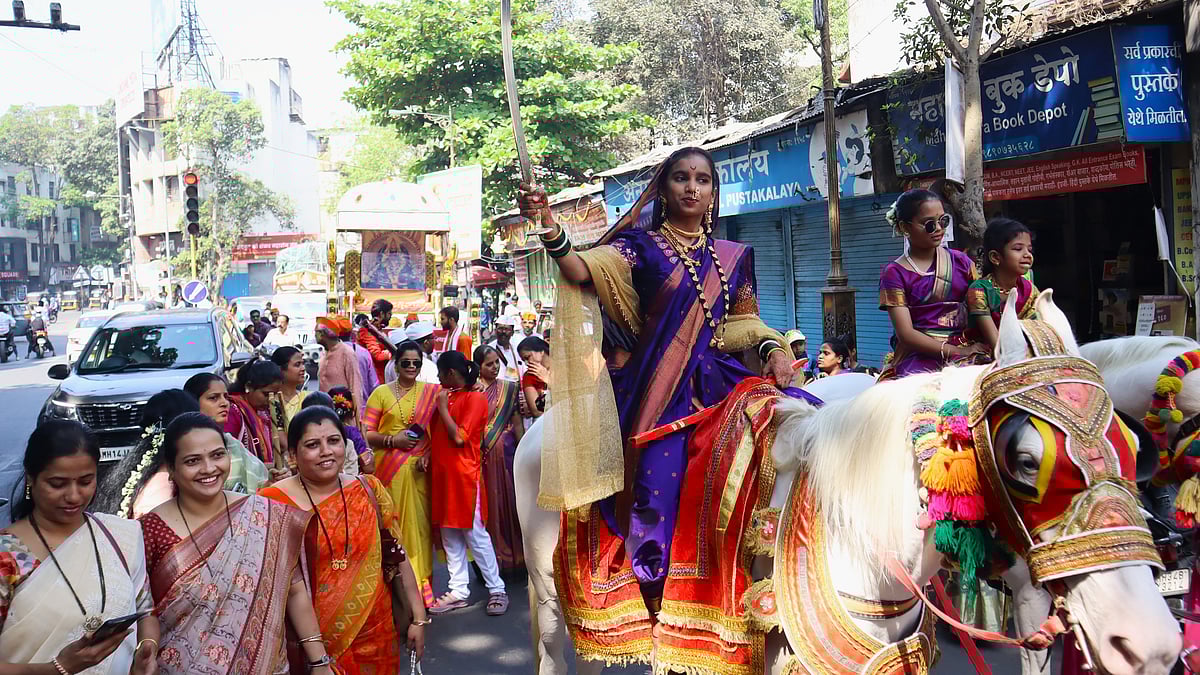 Dressed In Rich Purple Attire With Traditional Jewellery, She Reflects The Strength And Cultural Pride Associated With The Festival