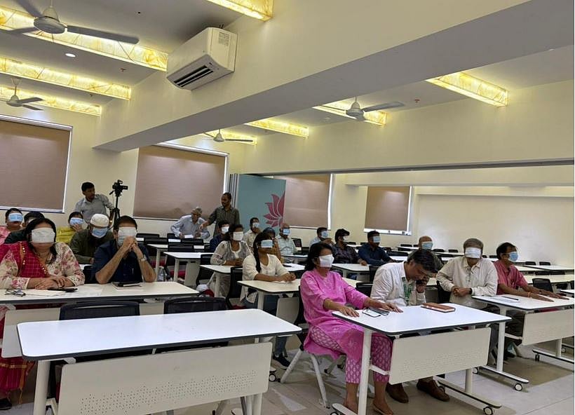 Staff members take part in a blindfolded simulation exercise during the Antar-Chakshu workshop at HSNC University.