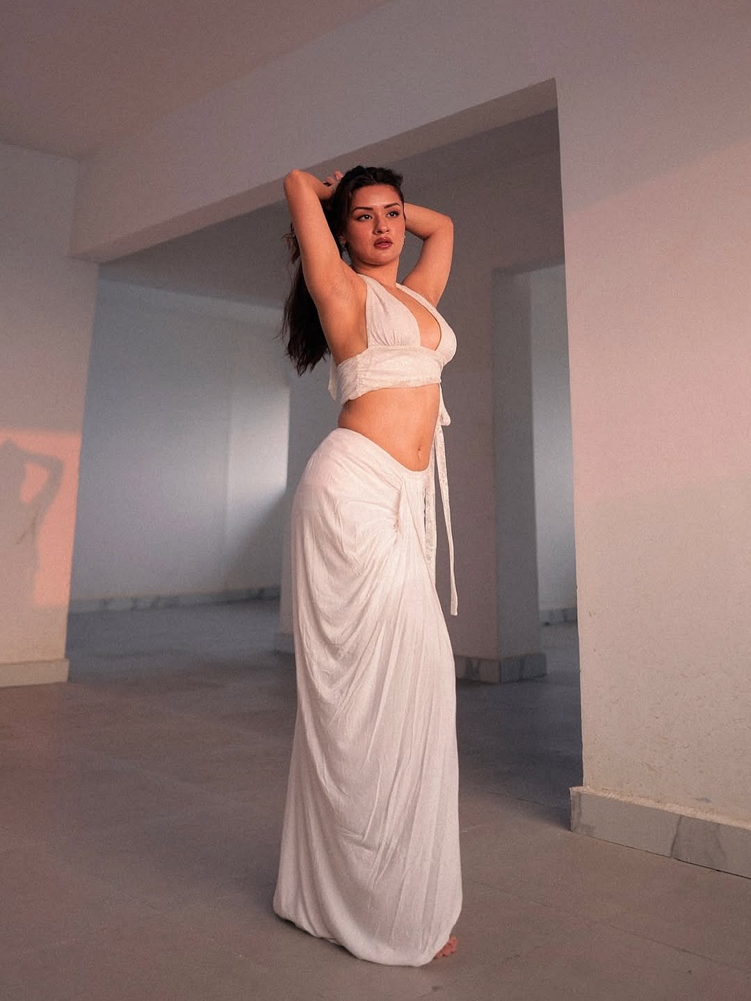 The fabric appears light and breezy, adding a soft, almost ethereal feel to her presence.

