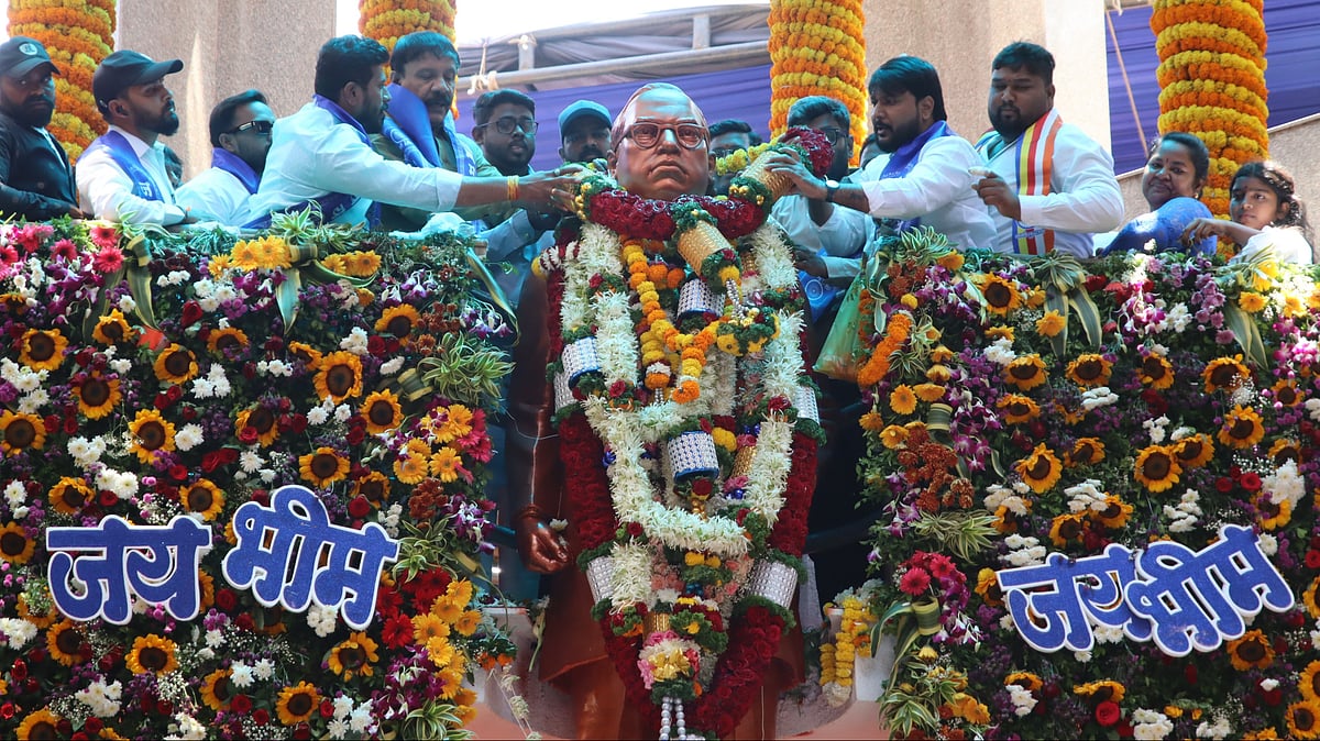 he statue of Babasaheb stood at the centre, adorned with garlands, as people offered respects with folded hands.