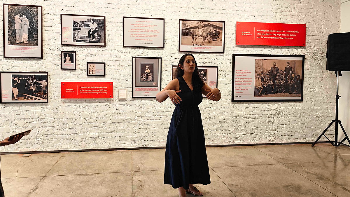 Malvika stands in front of a wall full of memories