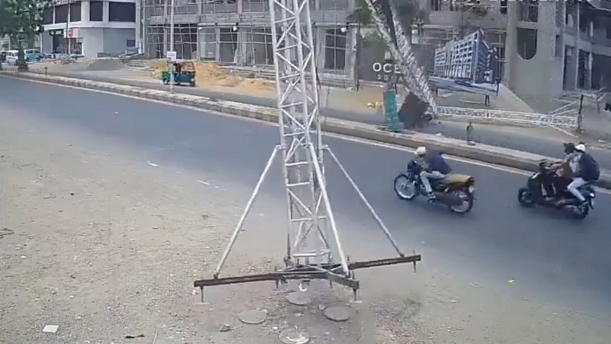 Watch: Biker, Scooty Rider Cheat Death After Hoarding Frame Falls In Gujarat’s Jamnagar