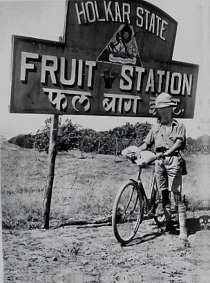 An Englishman standing with his bicycle in front of a Holkar State Fruit Station near Indore. Such fruit orchards supplied fresh produce to the public at affordable rates during the Holkar era.