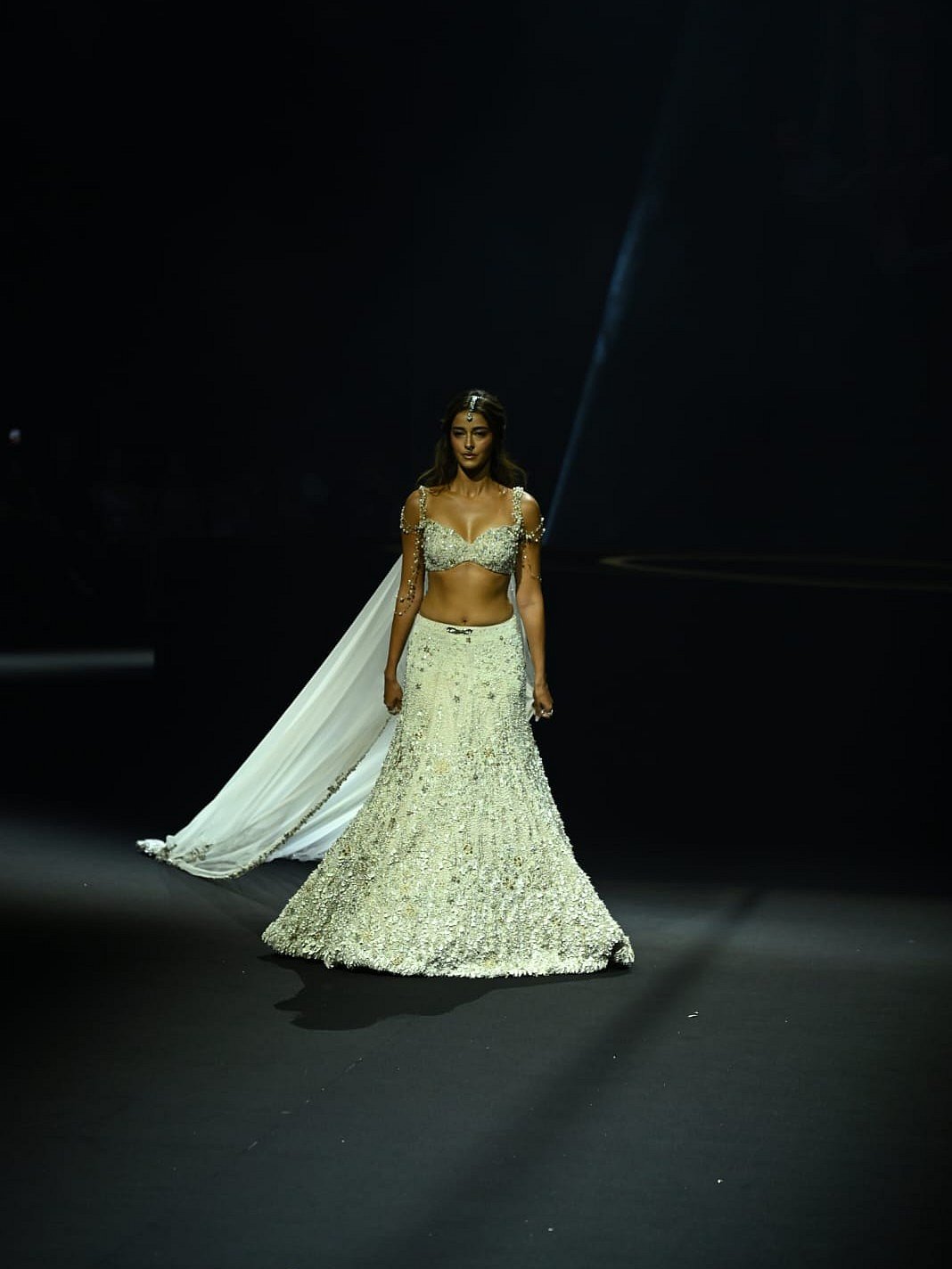 Ananya Panday walking the ramp in ivory lehenga 