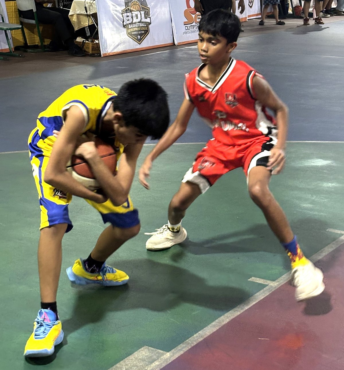 Players fight for ball possession during a Boys U-13 match of the Basketball Development League