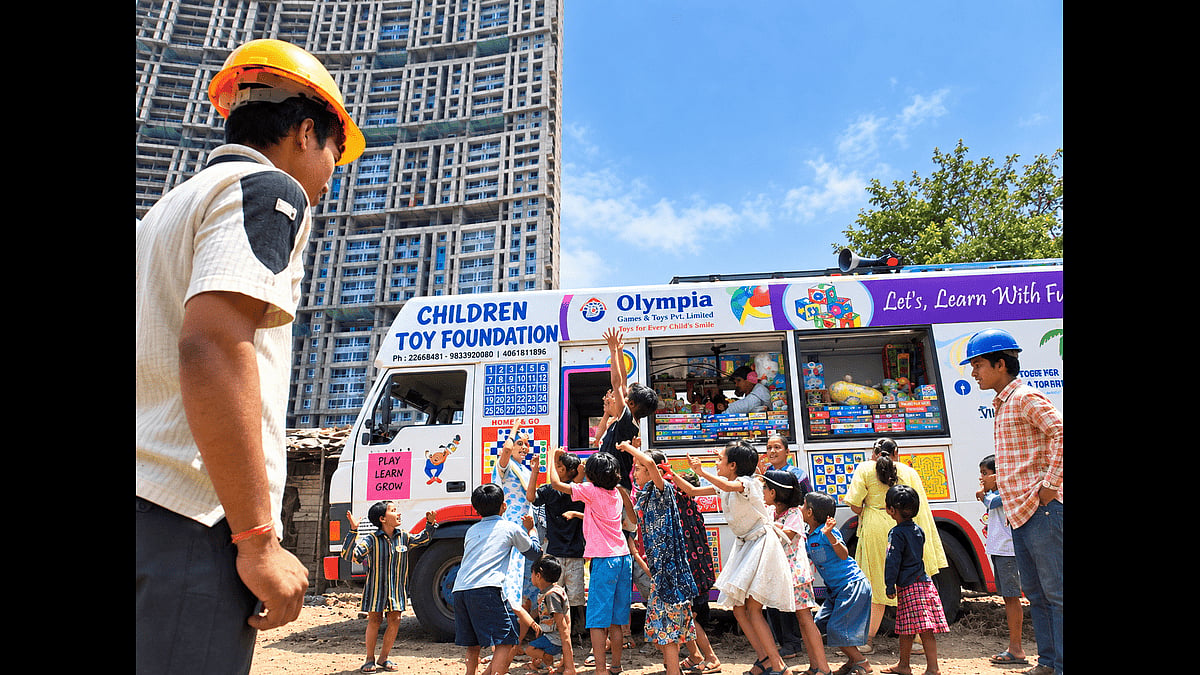 Children of construction workers get excited at the arrival of the mobile toy library