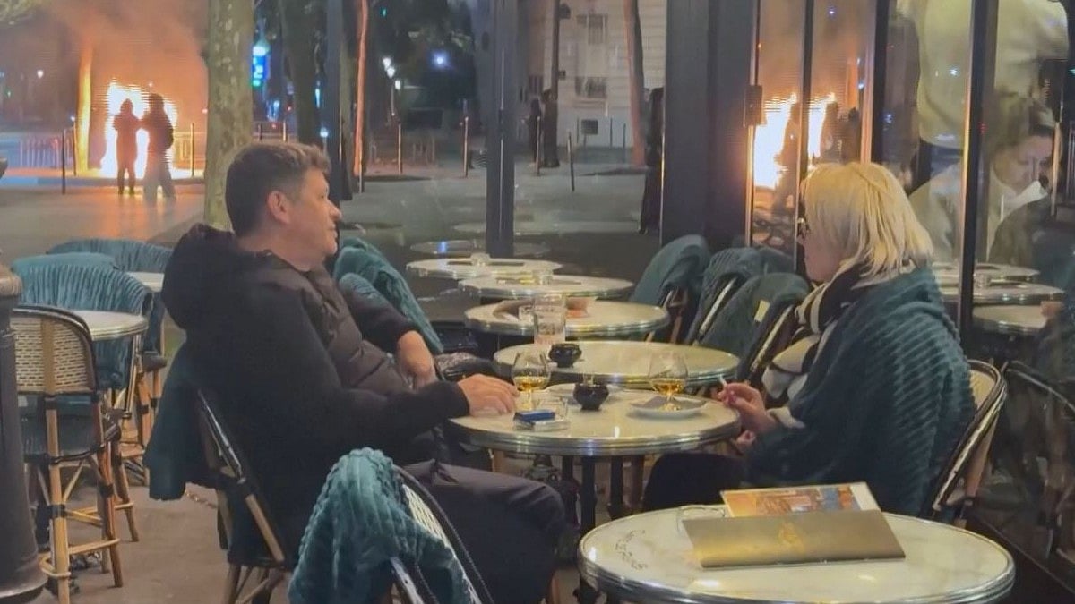 France Protests: Couple Sips Drink Calmly As Fires Rage Behind Them In Viral Video