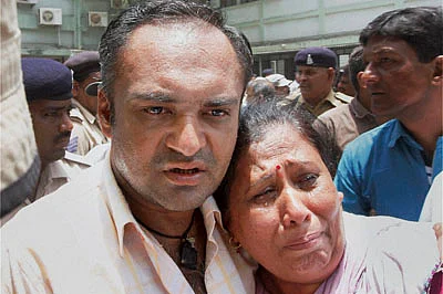 Ahmedabad: Family members of the convicts of the Gulbarg society massacre cry after the quantum of sentence was announced by the SIT court in Ahmedabad on Friday. PTI Photo(PTI6_17_2016_000209B) | 