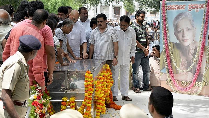 Relatives of Indian journalist Gauri Lankesh grieve by her body at the Ravindra Kalakshetra cultural centre in Bangalore on September 6, 2017. / AFP PHOTO / MANJUNATH KIRAN