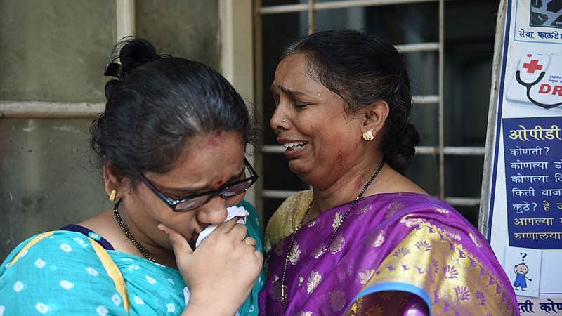 Indian relatives of victims injured at a stampede on a railway bridge react as they wait at a hospital in Mumbai on September 29, 2017.<br />Commuters stampeded on a Mumbai railway bridge during the morning rush hour September 29 killing at least 15 people, a disaster management official said. The cause of the stampede was not immediately known but Tanaji Pawar, a spokesman for Mumbai’s disaster management cell, warned that the death toll “is likely to go up”.<br />/ AFP PHOTO / PUNIT PARANJPE
