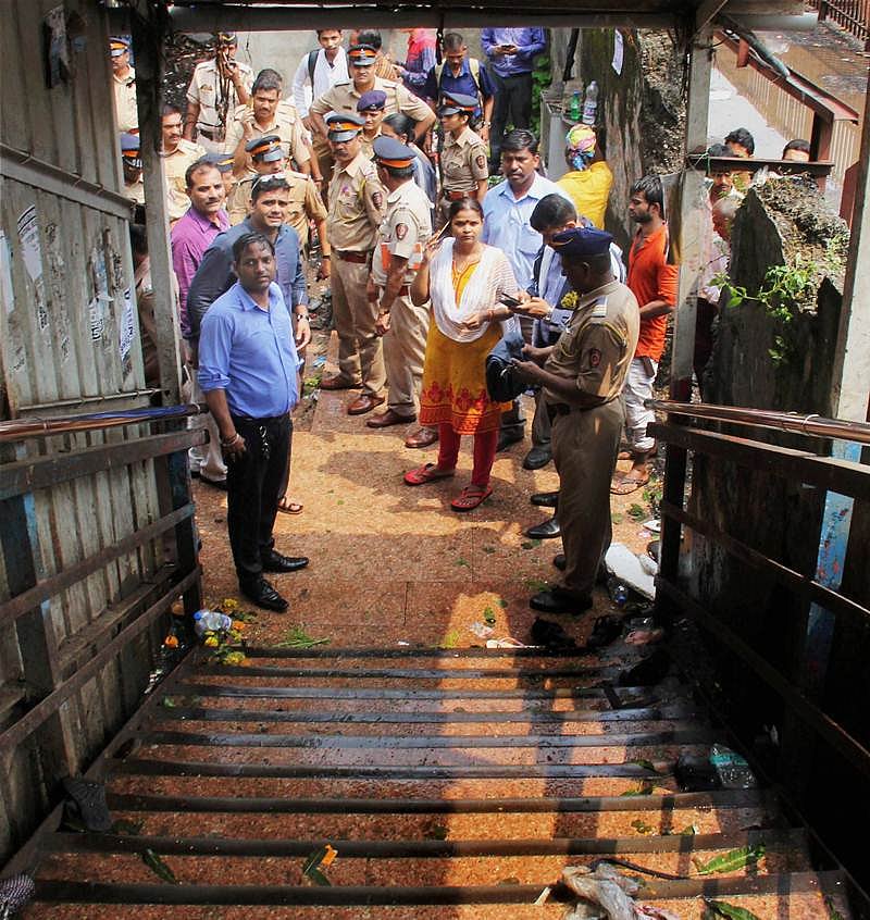 Mumbai: People and police look on at the site of a stampede that broke out on the Elpistion Railway Station bridge in Mumbai on Friday. PTI Photo