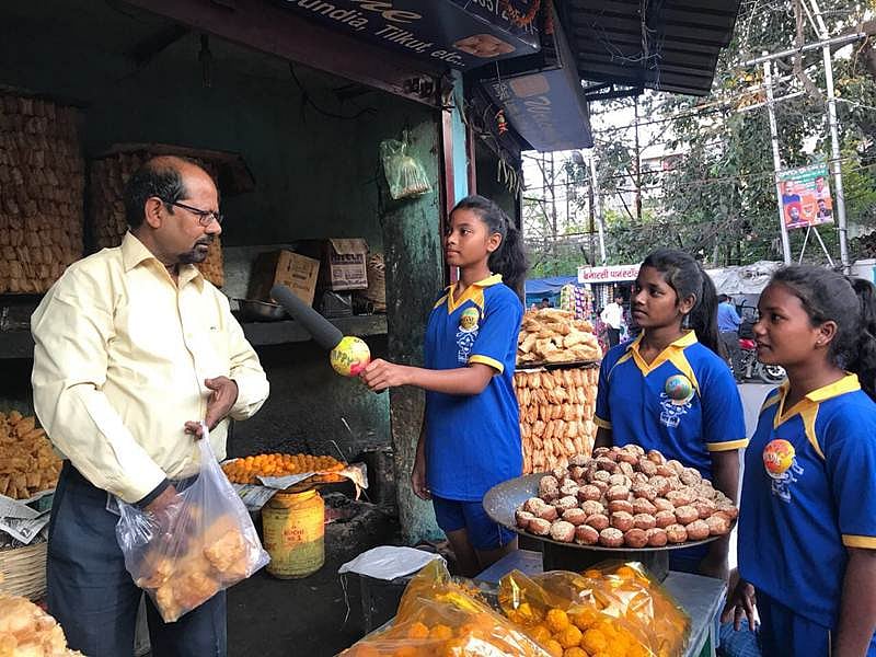 Reporters (from left) Anshu, Alisha and Rani talking to a shopkeeper in Ranchi