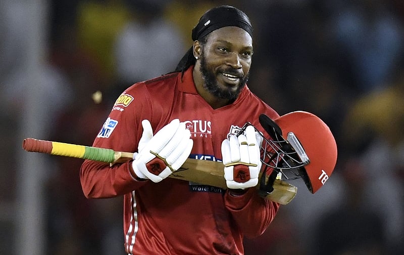 Chris Gayle celebrates his century during the 2018 IPL match between against Sunrisers Hyderabad. / AFP PHOTO / CHANDAN KHANNA