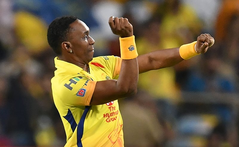Dwayne Bravo celebrates after taking the wicket during the 2018 IPL match. / AFP PHOTO / PUNIT PARANJPE / GETTYOUT