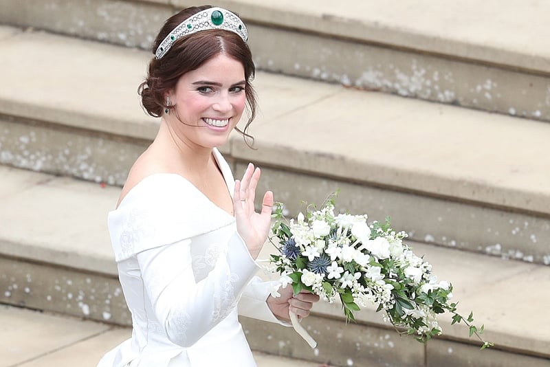 Britain’s Princess Eugenie of York waves as she arrives for her wedding to Jack Brooksbank at St George’s Chapel, Windsor. Photo by Andrew Matthews / POOL / AFP