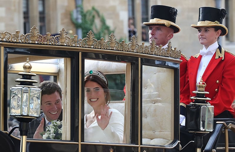 Britain’s Princess Eugenie of York and her husband Jack Brooksbank travel in the Scottish State Coach at the start of their carriage procession following their wedding at St George’s Chapel, Windsor Castle in Windsor, on October 12, 2018. (Photo by Gareth Fuller / POOL / AFP)