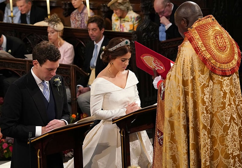 Britain’s Princess Eugenie of York (R) and Jack Brooksbank (L) kneel at the altar during their wedding ceremony at St George’s Chapel, Windsor Castle, in Windsor. Photo by Jonathan Brady / POOL / AFP