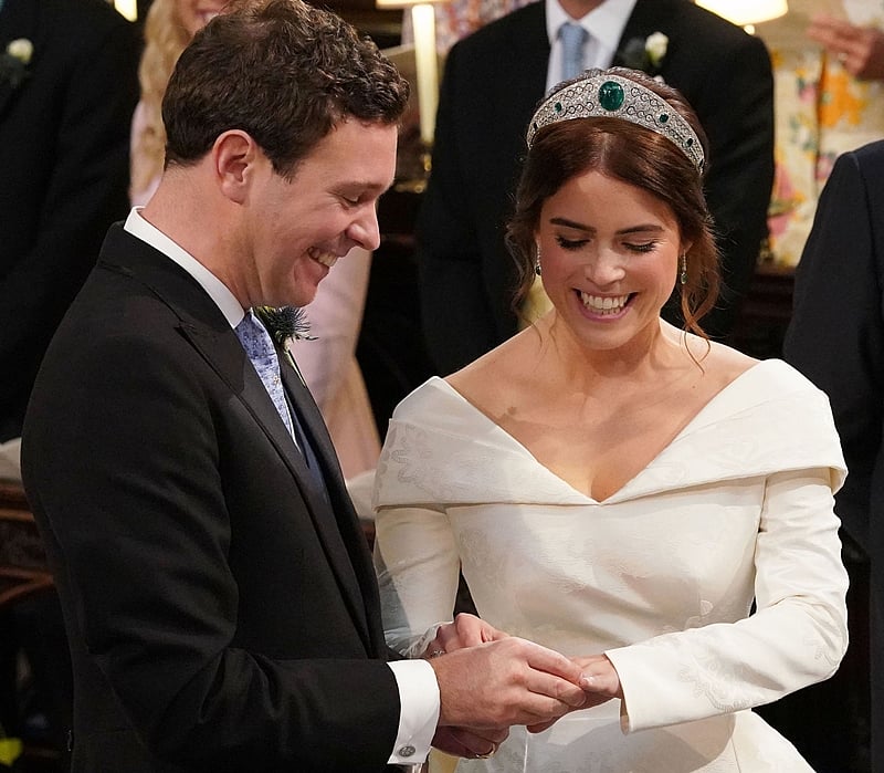 TOP SHOT – Britain’s Princess Eugenie of York (R) reacts during her wedding ceremony to Jack Brooksbank at St George’s Chapel, Windsor Castle, in Windsor. Photo by Jonathan Brady / POOL / AFP